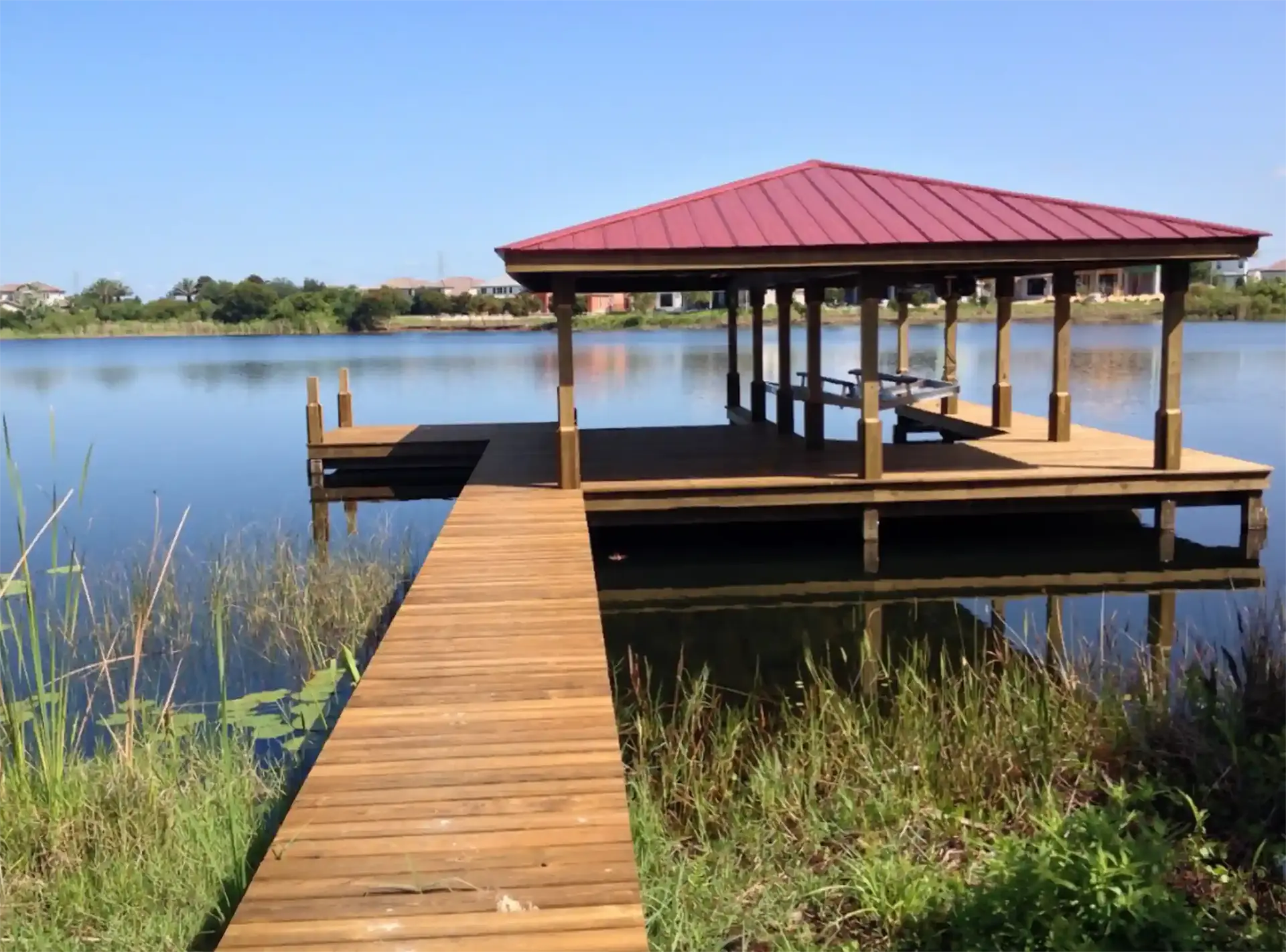 photo of a covered boat dock with a deck for lounging and sunning