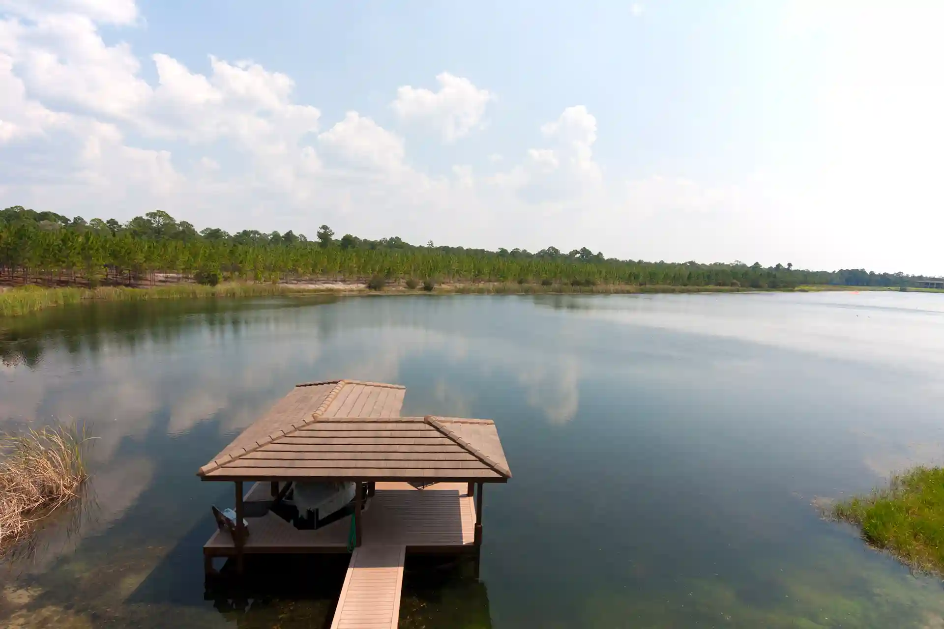 florida lake with a boat dock and boat house - Composite Docking Contractor in Central Florida and Composite Deck Building Company in Orlando Fl