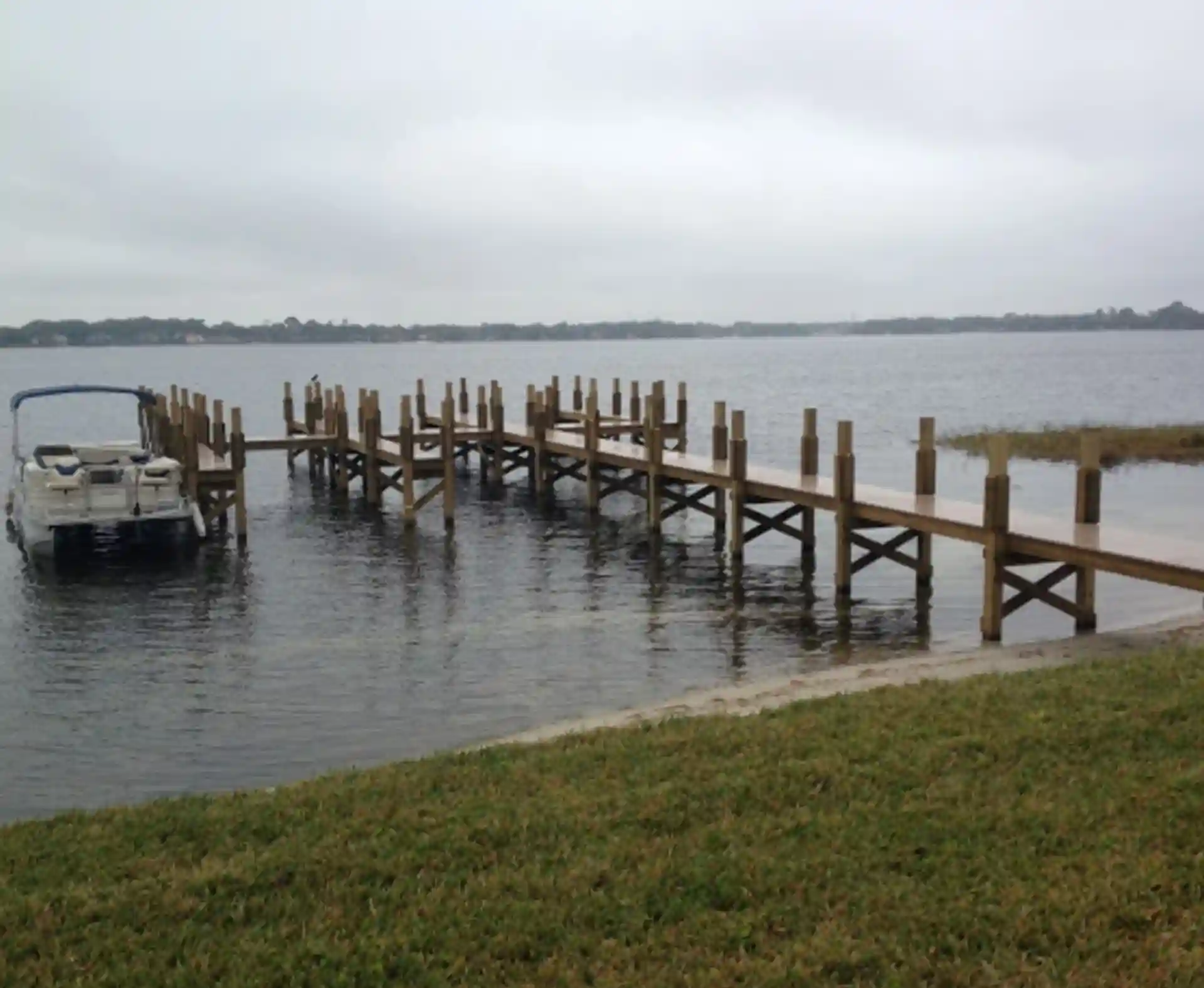 photo of a walkway over water to a boat dock