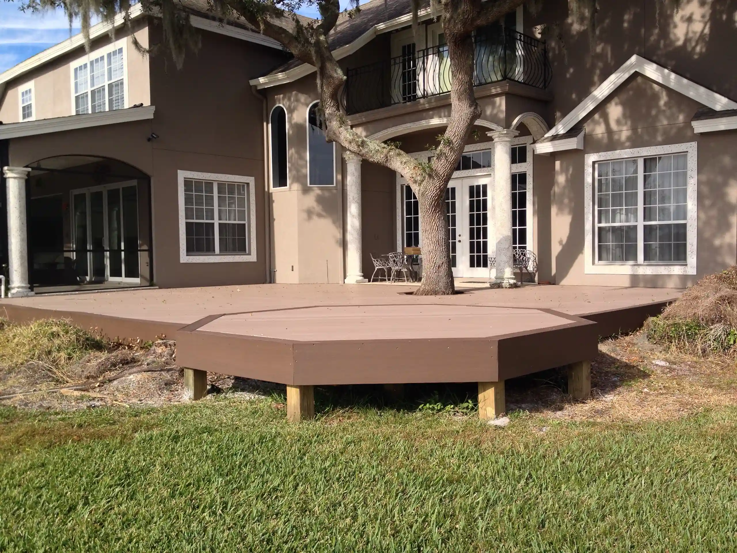 photo of a composite deck with an octagonal deck border and cutout for a tree