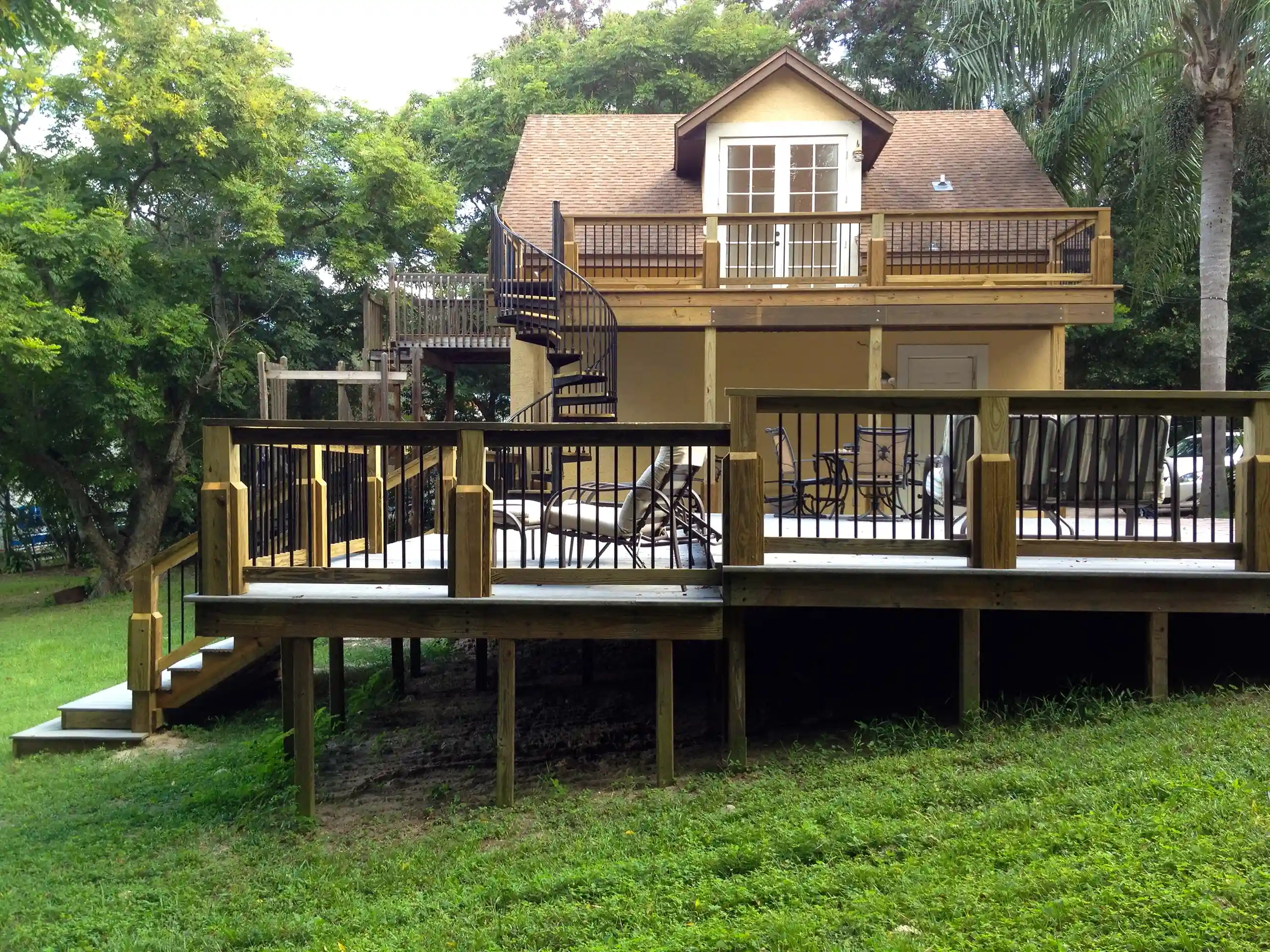 photo of a multi-level deck with a balcony deck and spiral staircase