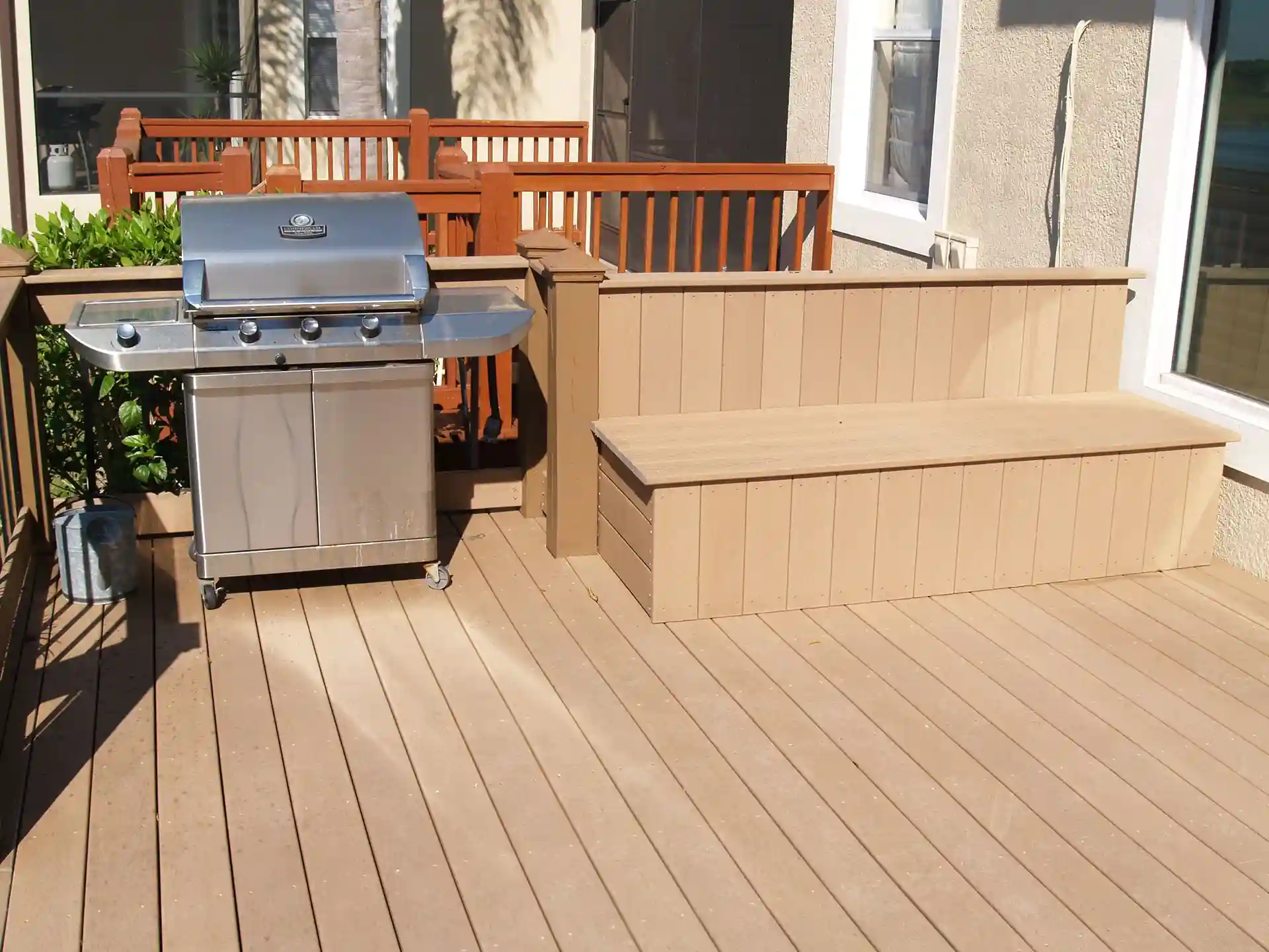 deck with an outdoor grilling station that serves as a summer kitchen - Outdoor Kitchens in Central Florida - Deck Benches and Planters Contractor in Orlando