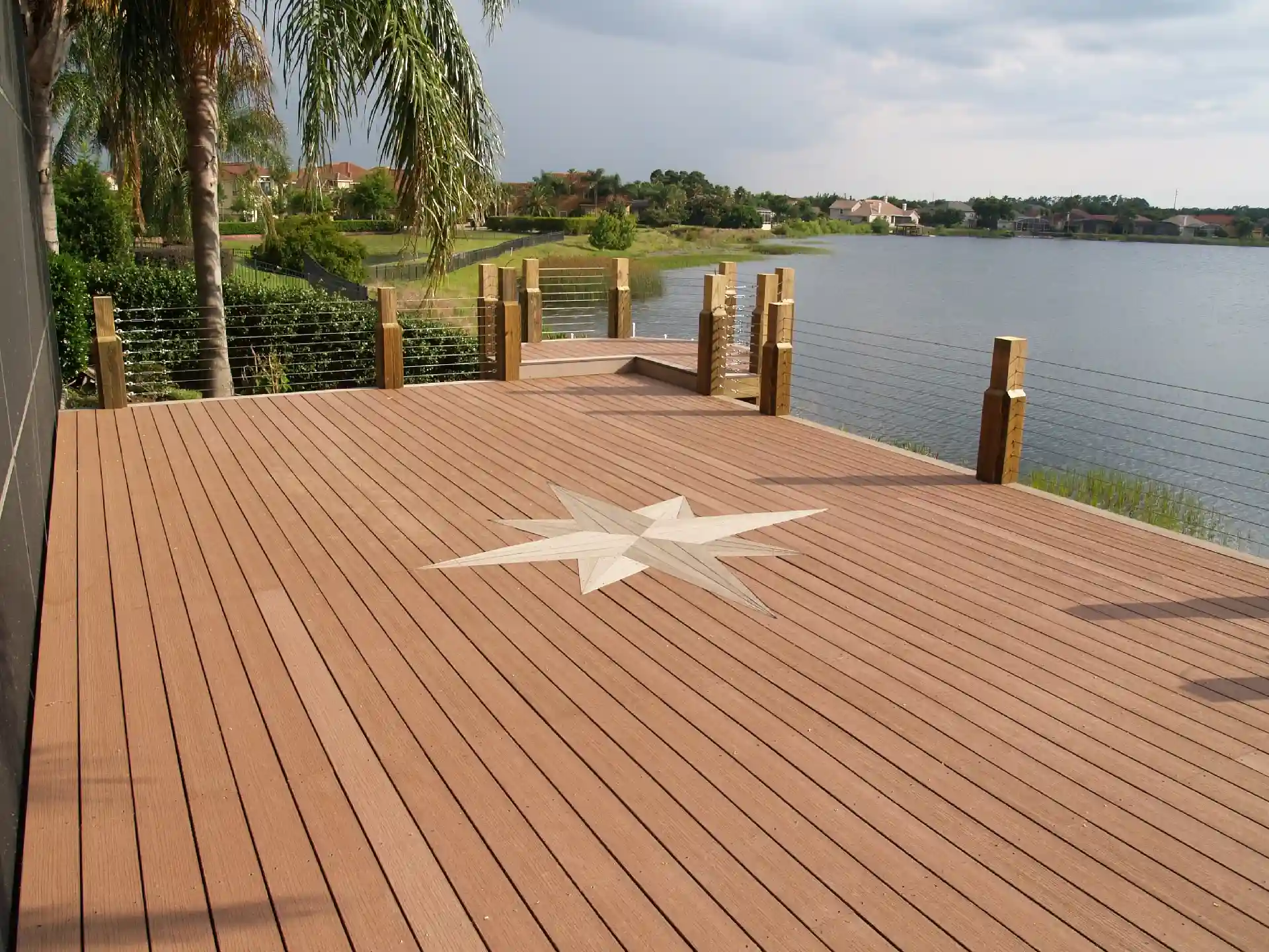 photo of a composite deck along with waterfront with a deck inlay - Trex Composite Deck Building Company near me In Central Florida