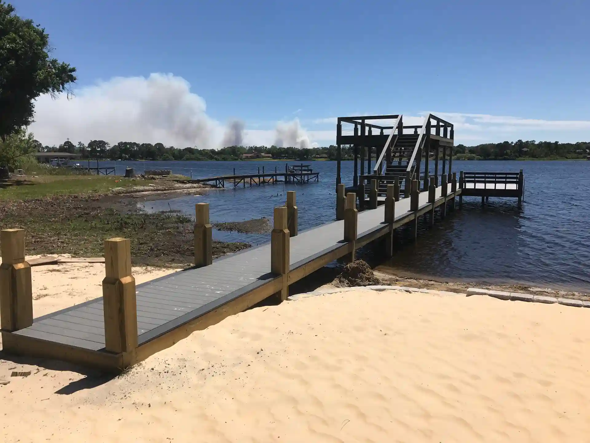 waterfront dock with composite decking, sturdy posts, and a two-story platform overlooking the lake