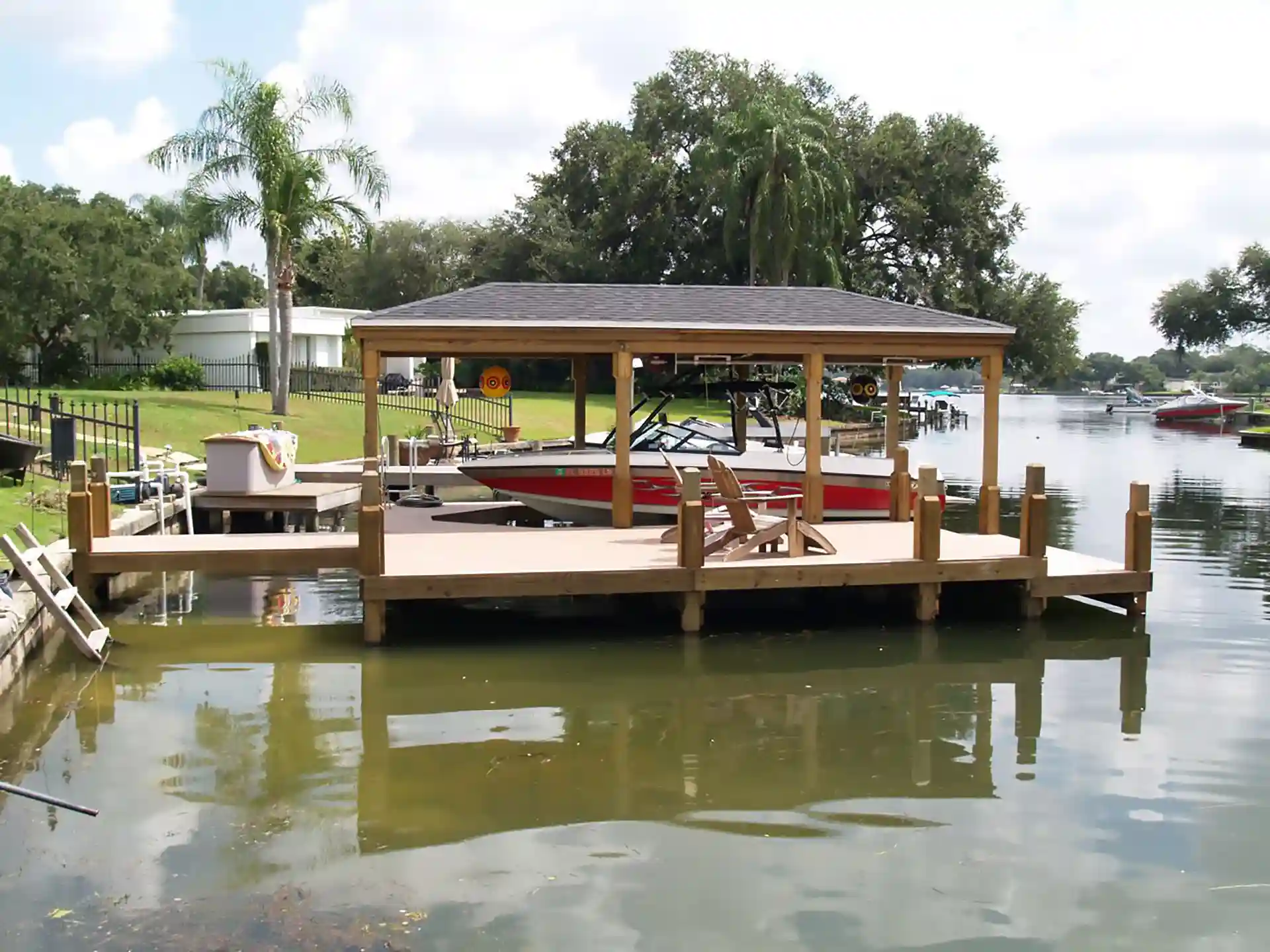 Photo of a boat dock and boat house with a boat lifted out of the water